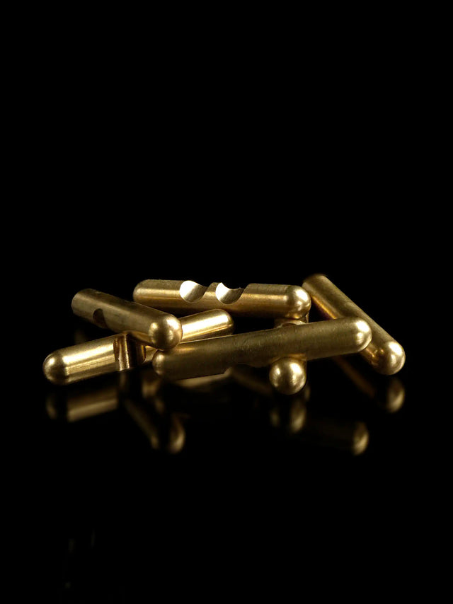 Pieces of the brass Craighill Jack Puzzle disassembled on Black background