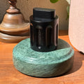 The black Curio Column Puzzle displayed on the Rajasthan Green marble Curio Plinth, lifestyle desk shot with globe