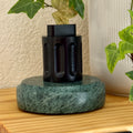 The black Curio Column Puzzle displayed on the Rajasthan Green marble Curio Plinth, lifestyle shelf shot with ivy plant