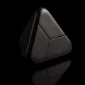 The black Curio Tetra Puzzle assembled on a black background