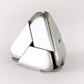 The stainless steel Craighill Tetra Puzzle nearly assembled on a gray background