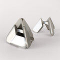 Two stainless steel Craighill Tetra Puzzles displayed together on a gray background