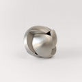 The stainless steel Craighill Venn Puzzle half assembled on a gray background